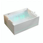 Tina de hidromasaje Mikonos con agua y cromoterapia LED encendida, mostrando sistema de jets y experiencia de spa premium.